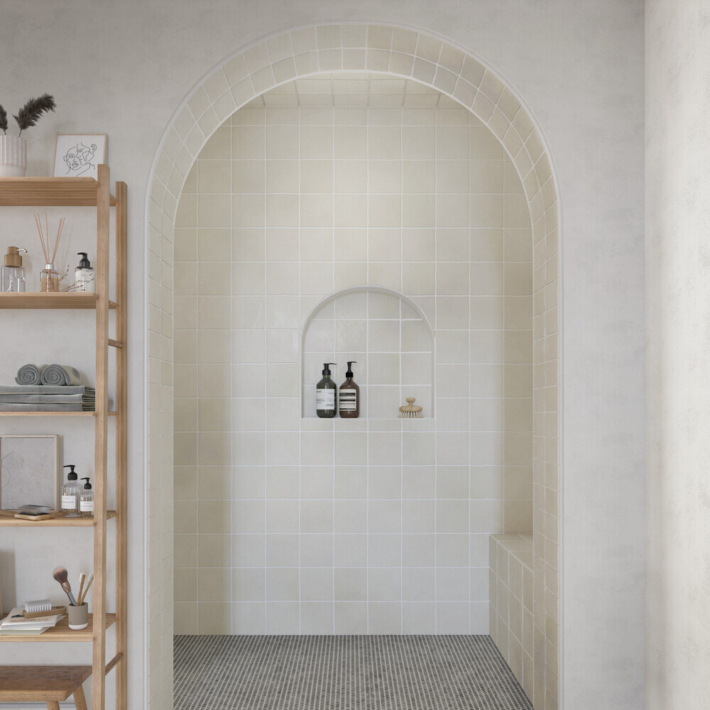 curved shower with tile backsplash