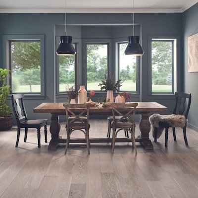 Hardwood floors in a Great Falls, MT, home dining room design with dark green paint