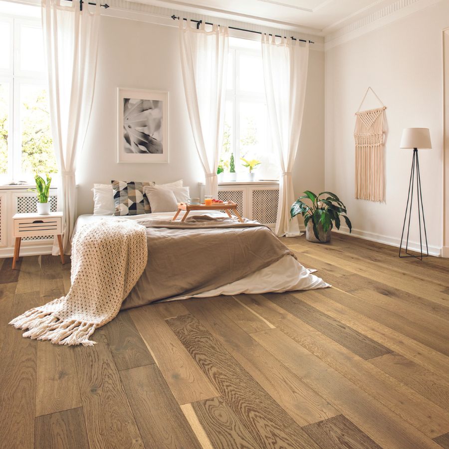 Hardwood flooring in bedroom, plants, white walls